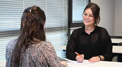 deux étudiant face à face en train de travailler en souriant